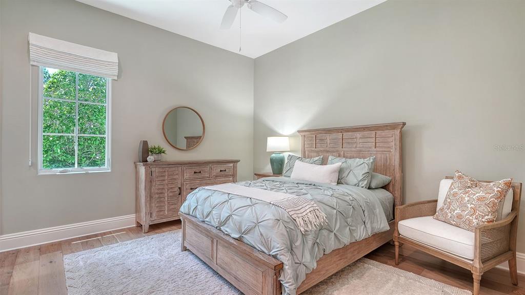 7975 Matera Court Lakewood Ranch, FL 34202 - Photo 33 of 83 a bedroom with a bed a mirror and a window