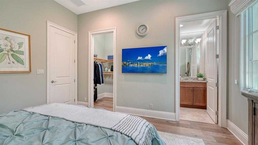 7975 Matera Court Lakewood Ranch, FL 34202 - Photo 34 of 83 a bedroom with a bed and a view of bathroom