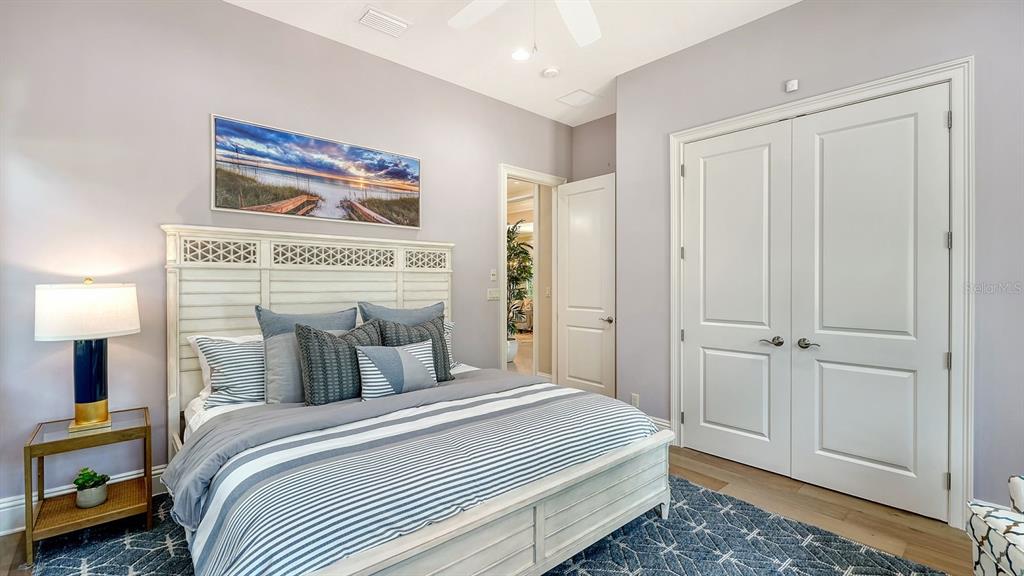 7975 Matera Court Lakewood Ranch, FL 34202 - Photo 39 of 83 a bedroom with a bed and a painting