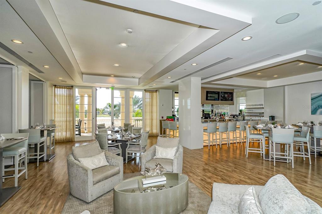 7975 Matera Court Lakewood Ranch, FL 34202 - Photo 67 of 83 a living room with lots of furniture and view of kitchen