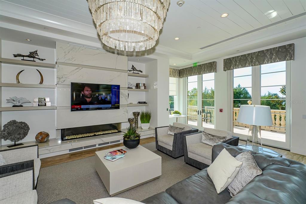 7975 Matera Court Lakewood Ranch, FL 34202 - Photo 71 of 83 a living room with furniture a flat screen tv and a large window