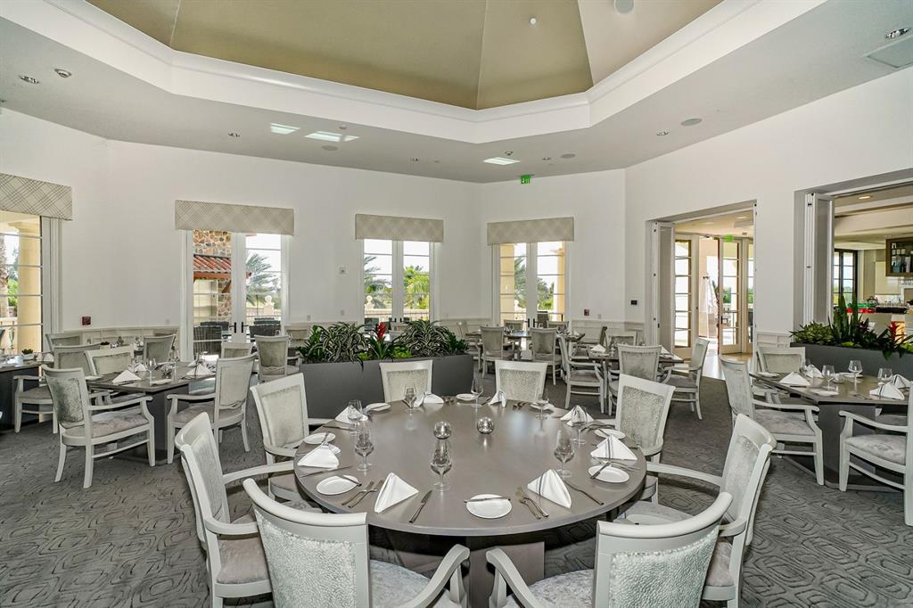 7975 Matera Court Lakewood Ranch, FL 34202 - Photo 72 of 83 a view of a dining room with furniture and wooden floor