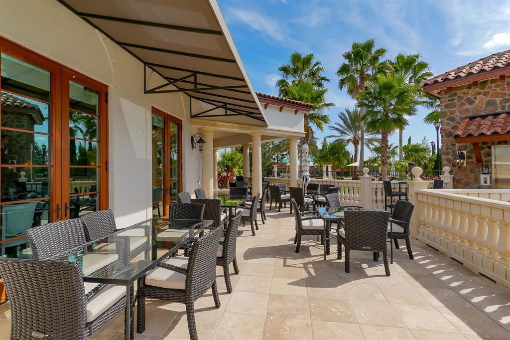 7975 Matera Court Lakewood Ranch, FL 34202 - Photo 75 of 83 a view of a patio with a table and chairs and potted plants