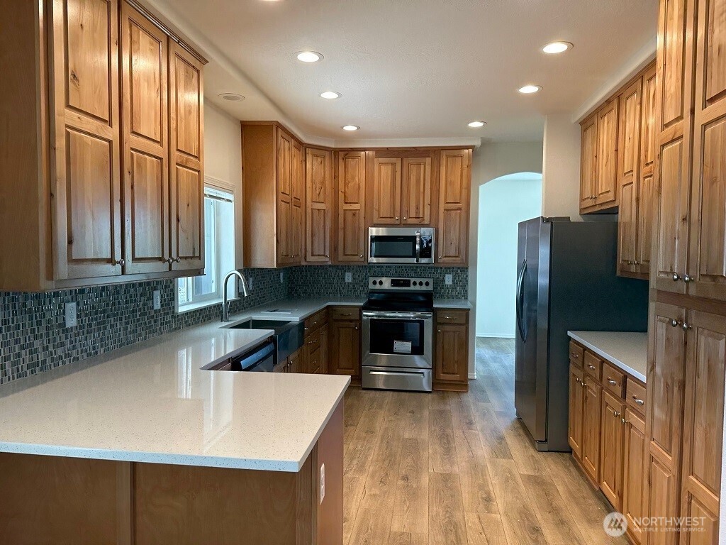 2101 South 324th Street, Unit 228 Federal Way, WA 98003 - Photo 3 of 11 a kitchen with stainless steel appliances a refrigerator sink and stove