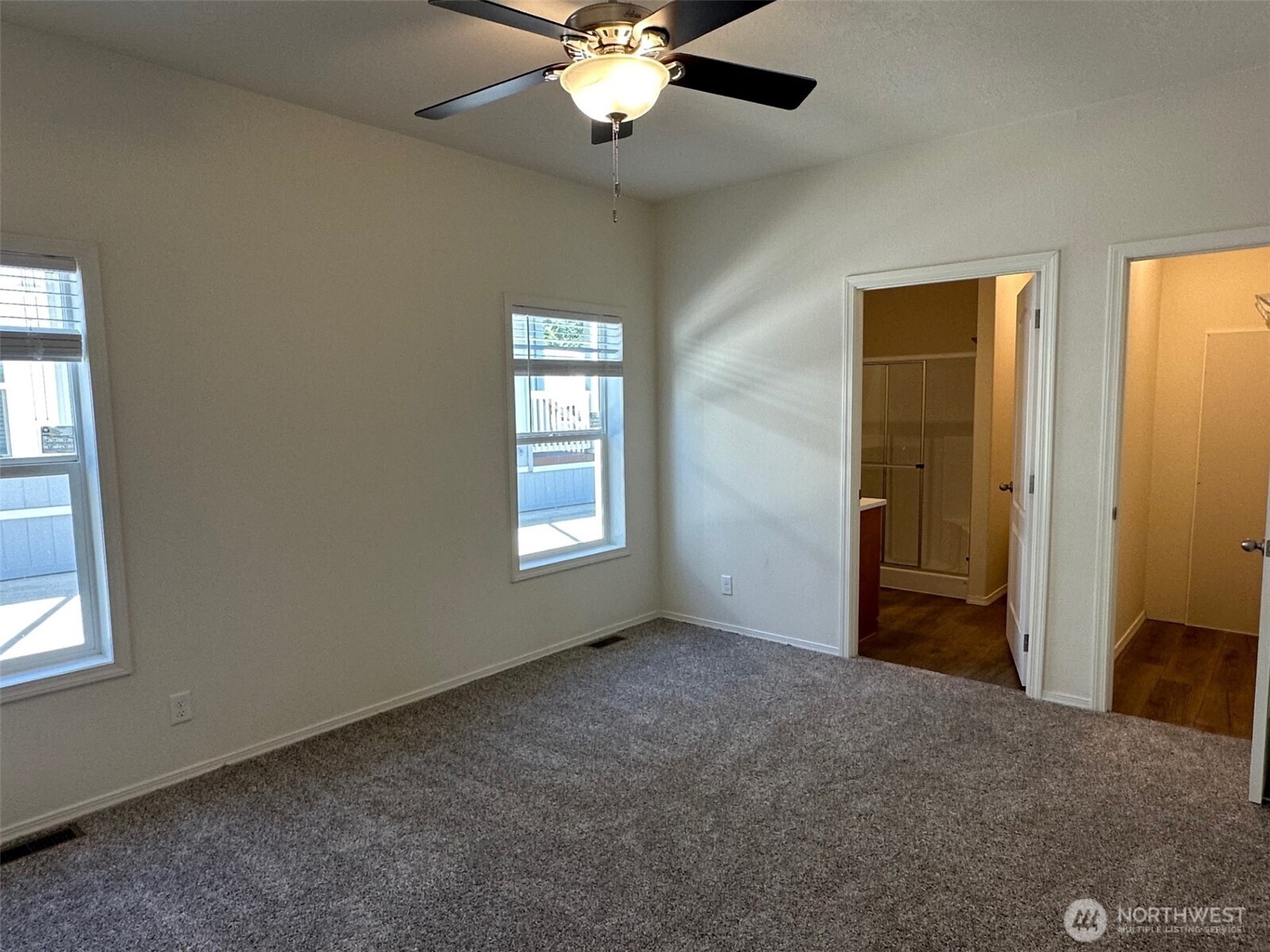 2101 South 324th Street, Unit 228 Federal Way, WA 98003 - Photo 5 of 11 an empty room with windows and fan