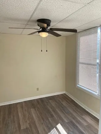 a view of a room with wooden floor and a window