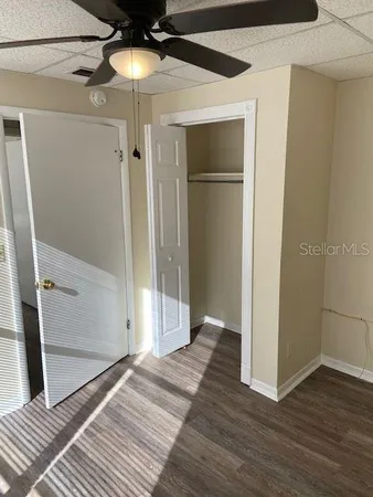 a view of a room with wooden floor