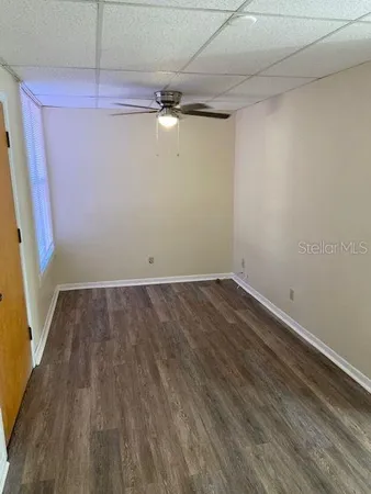 a view of a room with wooden floor and white walls