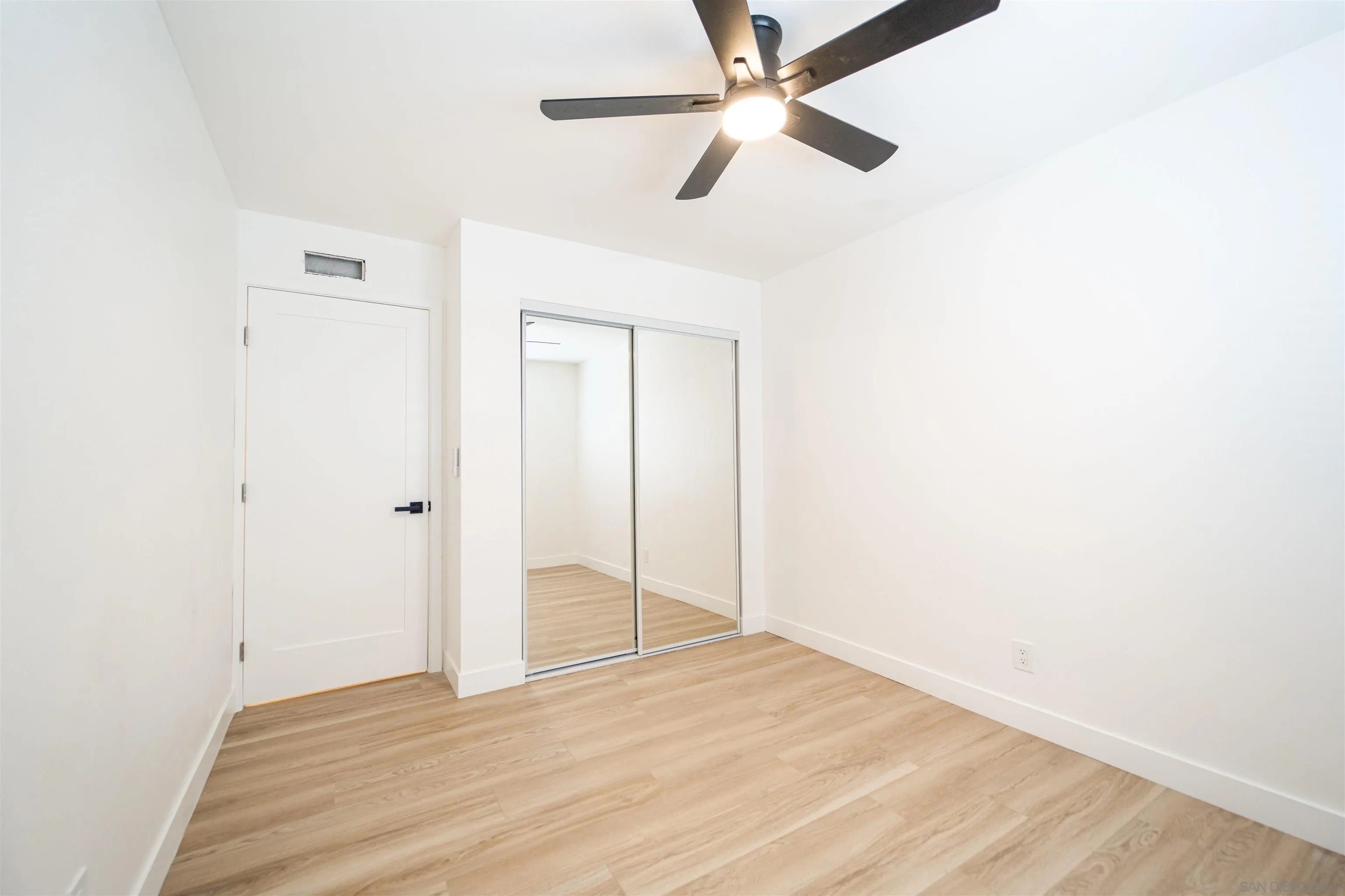 1306 West San Ysidro Boulevard, Unit D San Diego, CA 92173 - Photo 12 of 22 a view of empty room with wooden floor