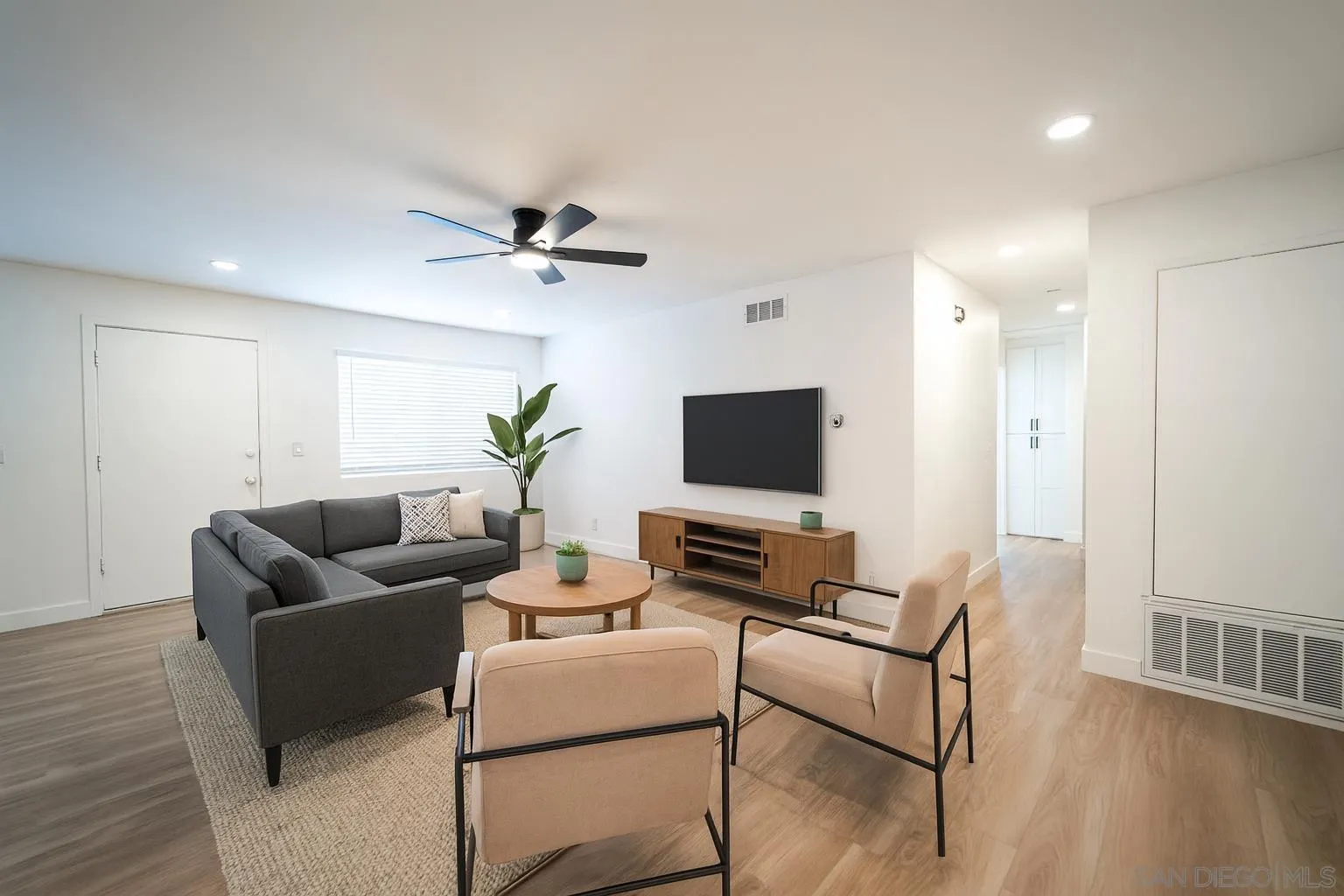 1306 West San Ysidro Boulevard, Unit D San Diego, CA 92173 - Photo 21 of 22 a living room with furniture and a flat screen tv