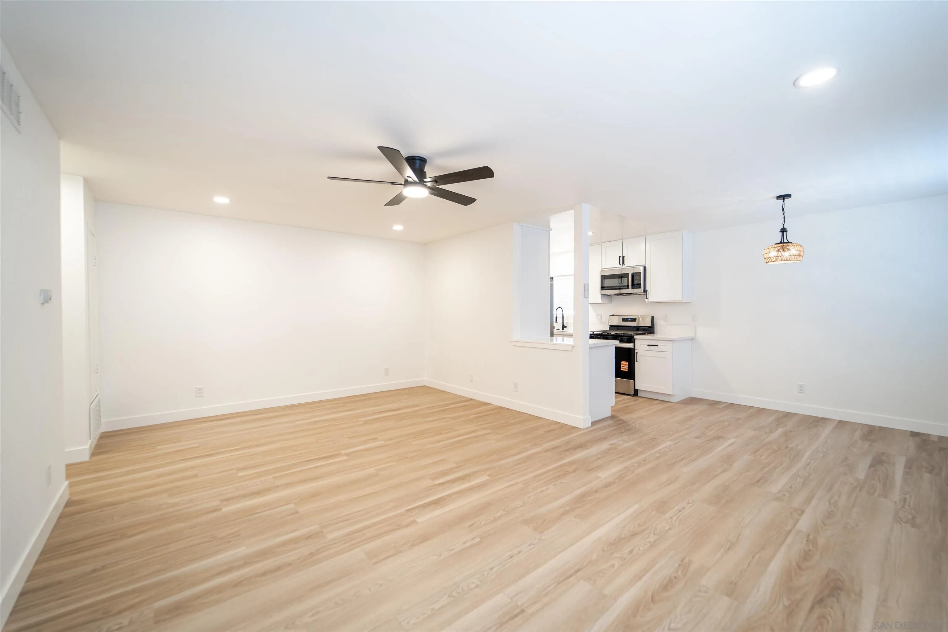 1306 West San Ysidro Boulevard, Unit D San Diego, CA 92173 - Photo 4 of 22 a view of empty room with wooden floor and ceiling fan