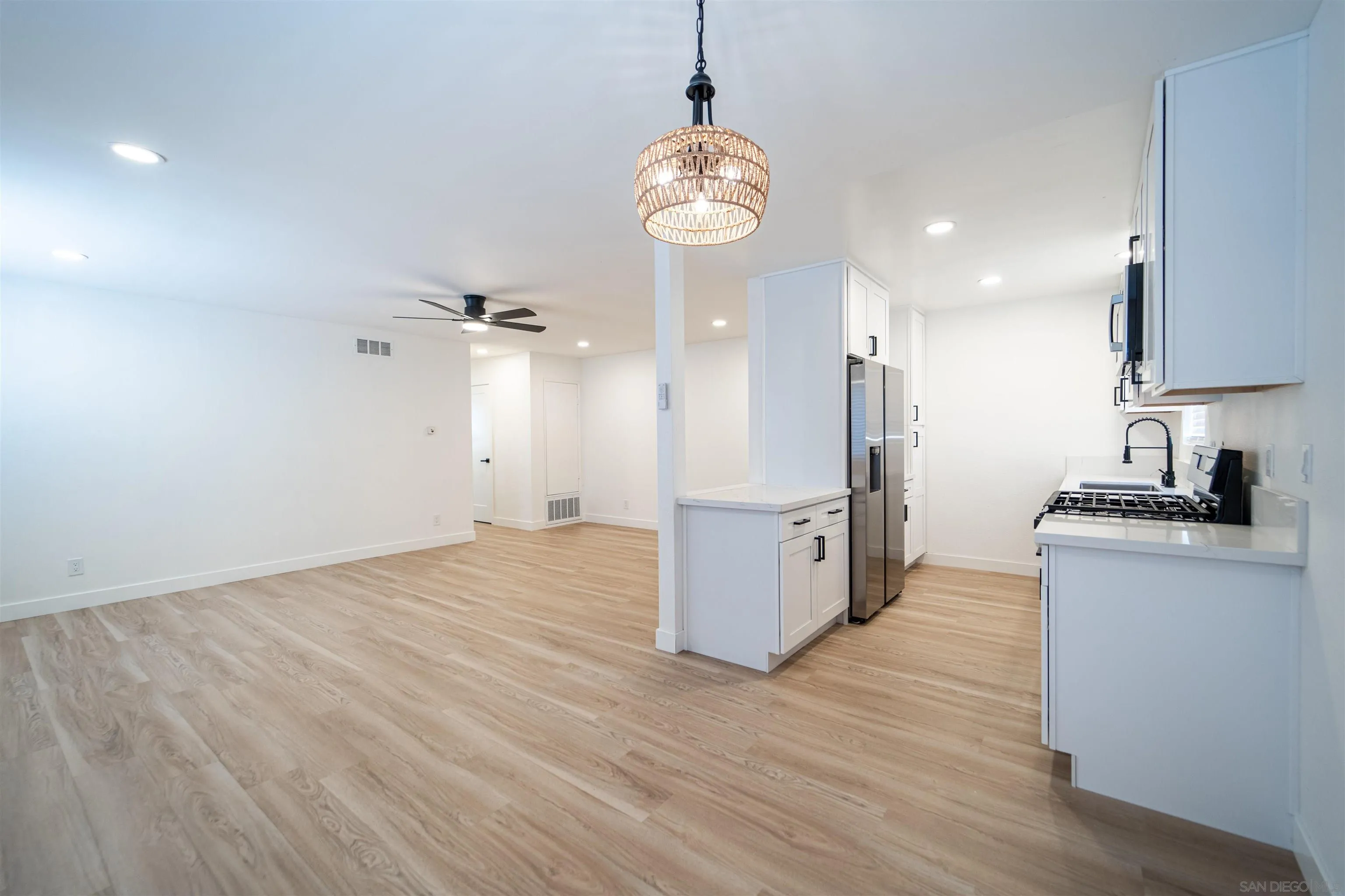 1306 West San Ysidro Boulevard, Unit D San Diego, CA 92173 - Photo 7 of 22 a view of a kitchen with stove and wooden floor