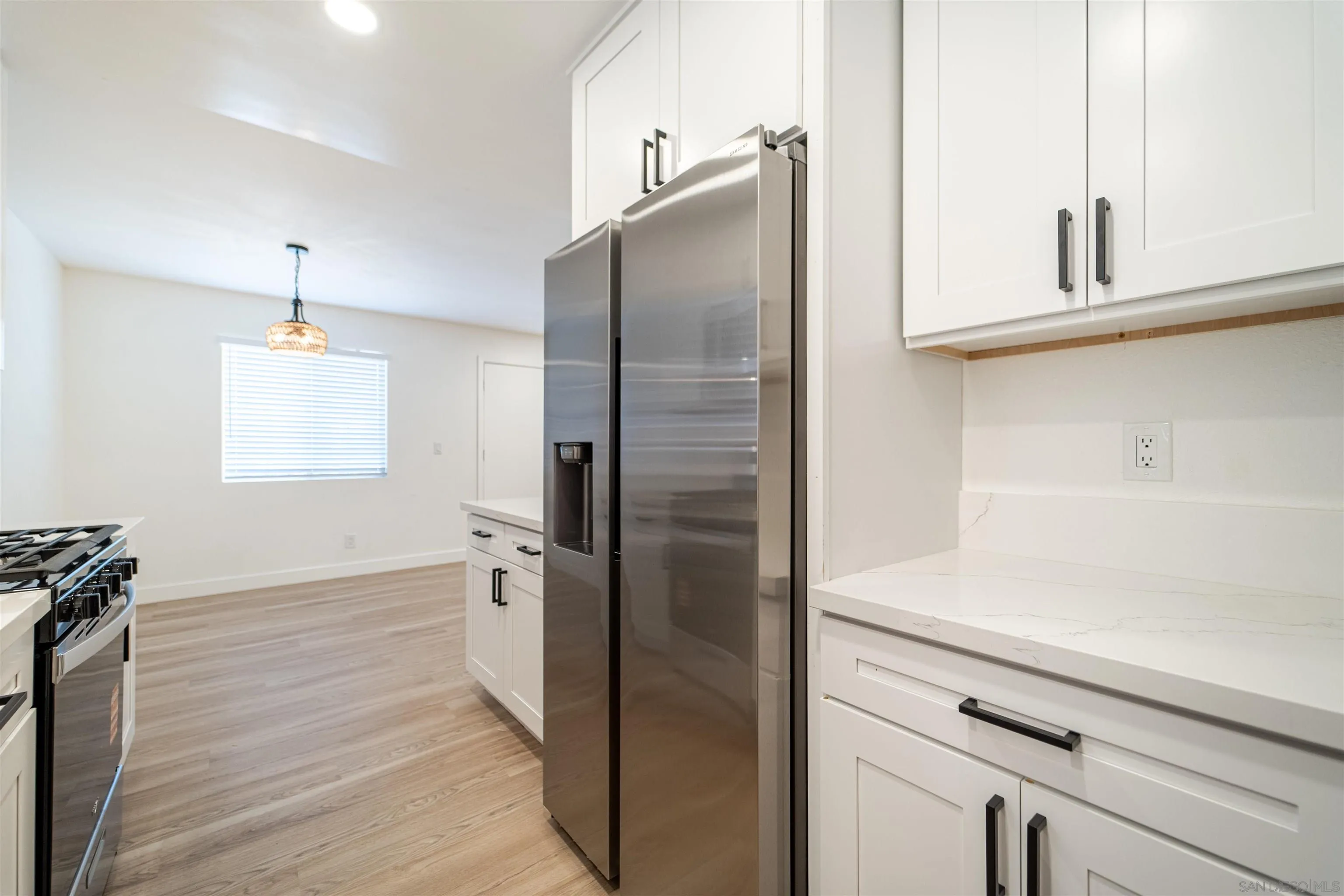 1306 West San Ysidro Boulevard, Unit D San Diego, CA 92173 - Photo 9 of 22 a kitchen with stainless steel appliances a refrigerator and cabinets