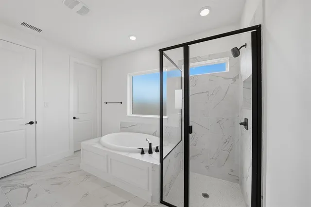 a bathroom with a bathtub and a shower