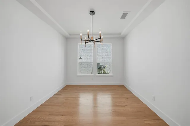 a view of room with window wooden floor and windows