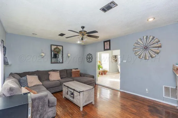 a living room with furniture and a potted plant
