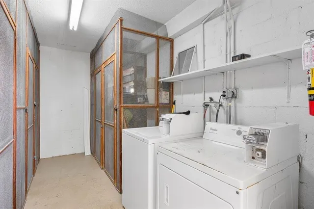 a view of washer and dryer with kitchen in the background