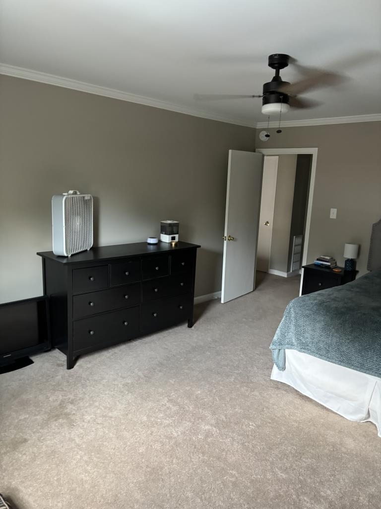 5726 Quince Road, Unit 2 Memphis, TN 38119 - Photo 2 of 7 Bedroom featuring crown molding, a ceiling fan, and light colored carpet