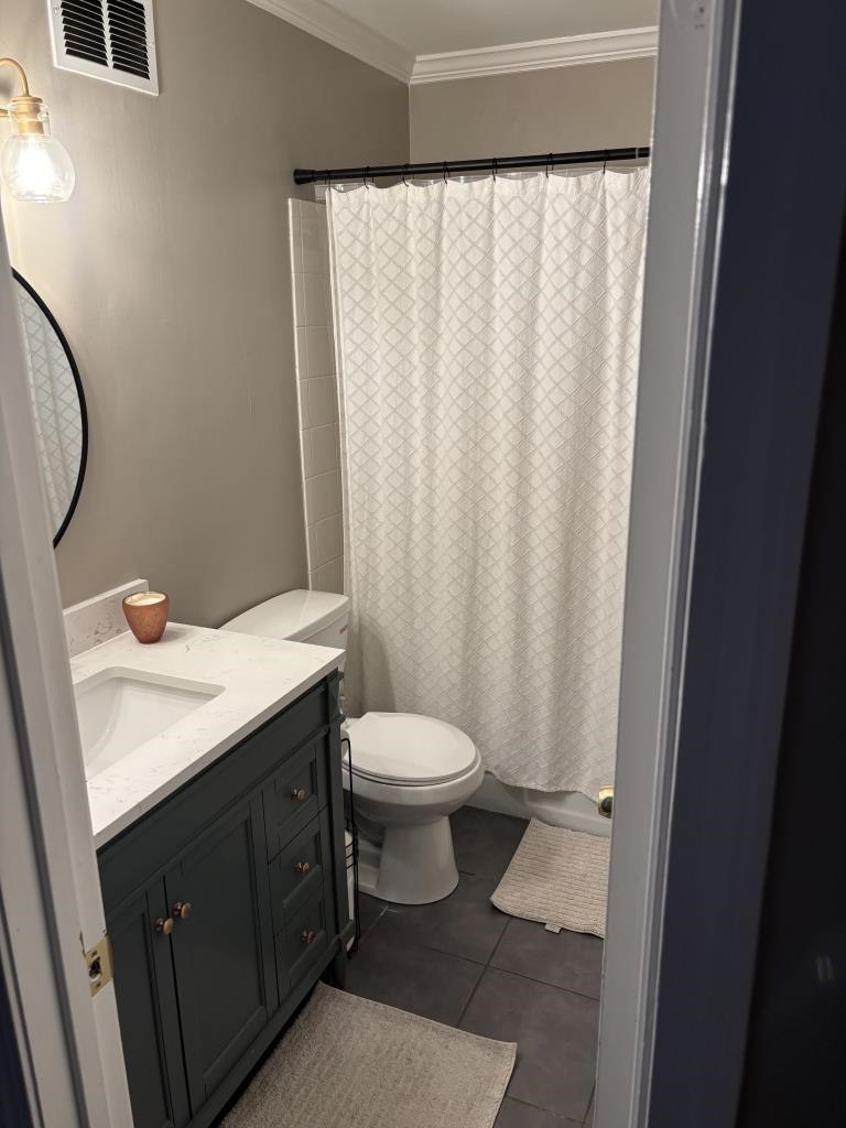 5726 Quince Road, Unit 2 Memphis, TN 38119 - Photo 3 of 7 Full bath with vanity, crown molding, and dark tile patterned flooring