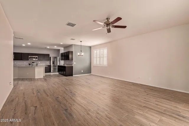 a view of a kitchen with a sink and a refrigerator