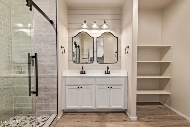 a bathroom with a double vanity sink and a mirror