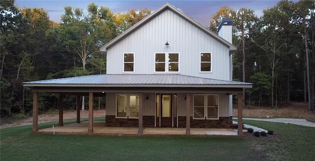 a view of a house with a yard and sitting area