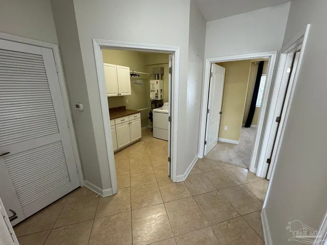 a utility room with cabinets washer and dryer