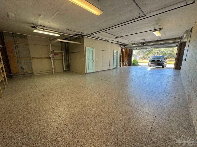 a view of a balcony with two chairs and a barbeque