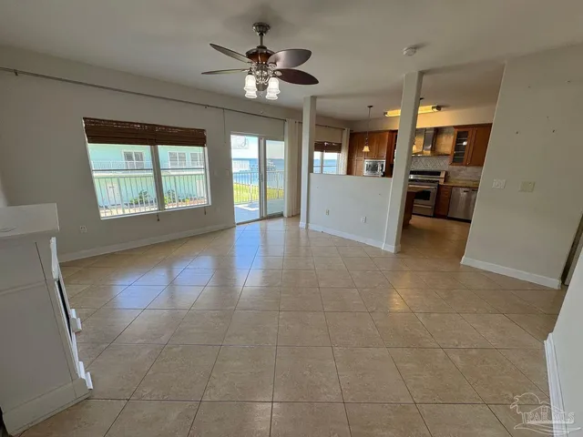 a view of an empty room with a kitchen