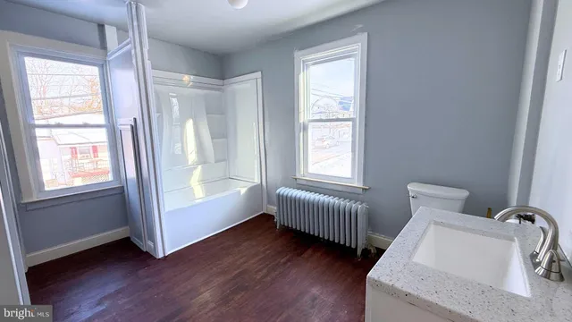 a room with two beds and a window