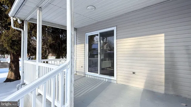 a view of a house with snow in front of house