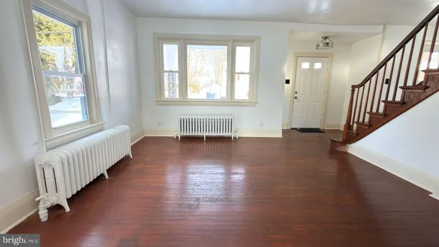 a view of an entryway with wooden floor and windows