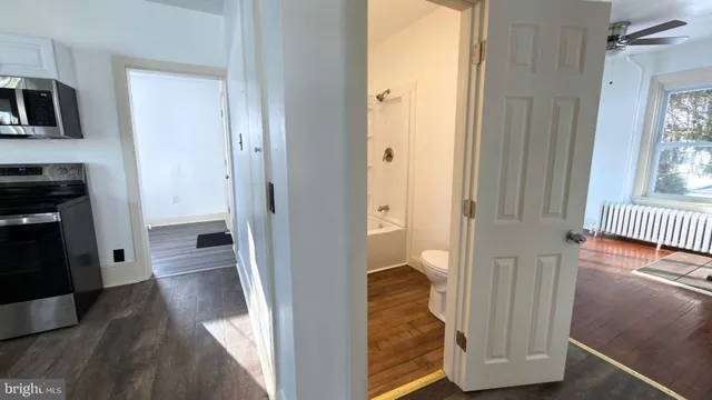 a view of a hallway with wooden floor and dining room