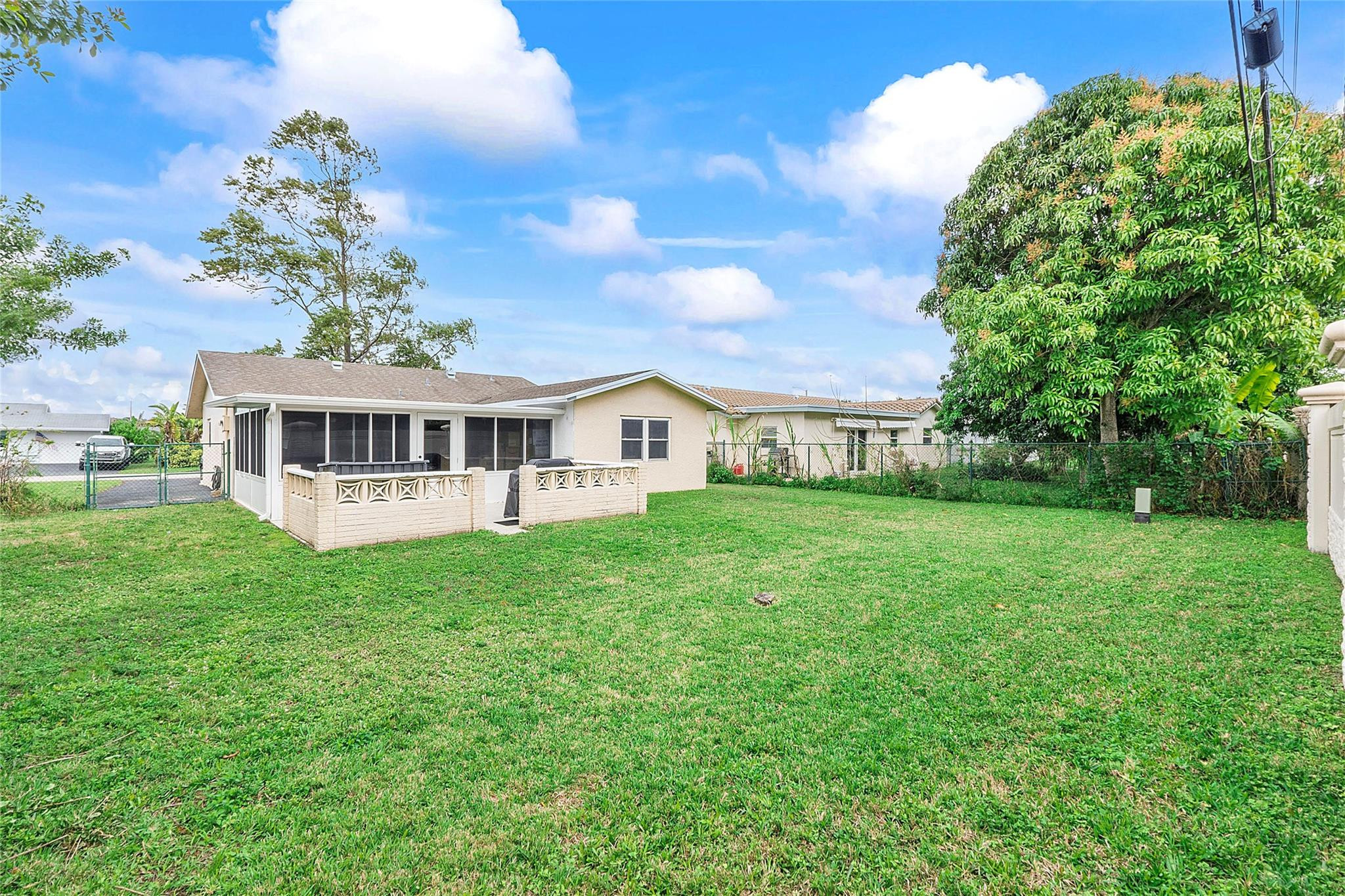 9804 Northwest 70th Street Tamarac, FL 33321 - Photo 11 of 12 a front view of a house with a garden