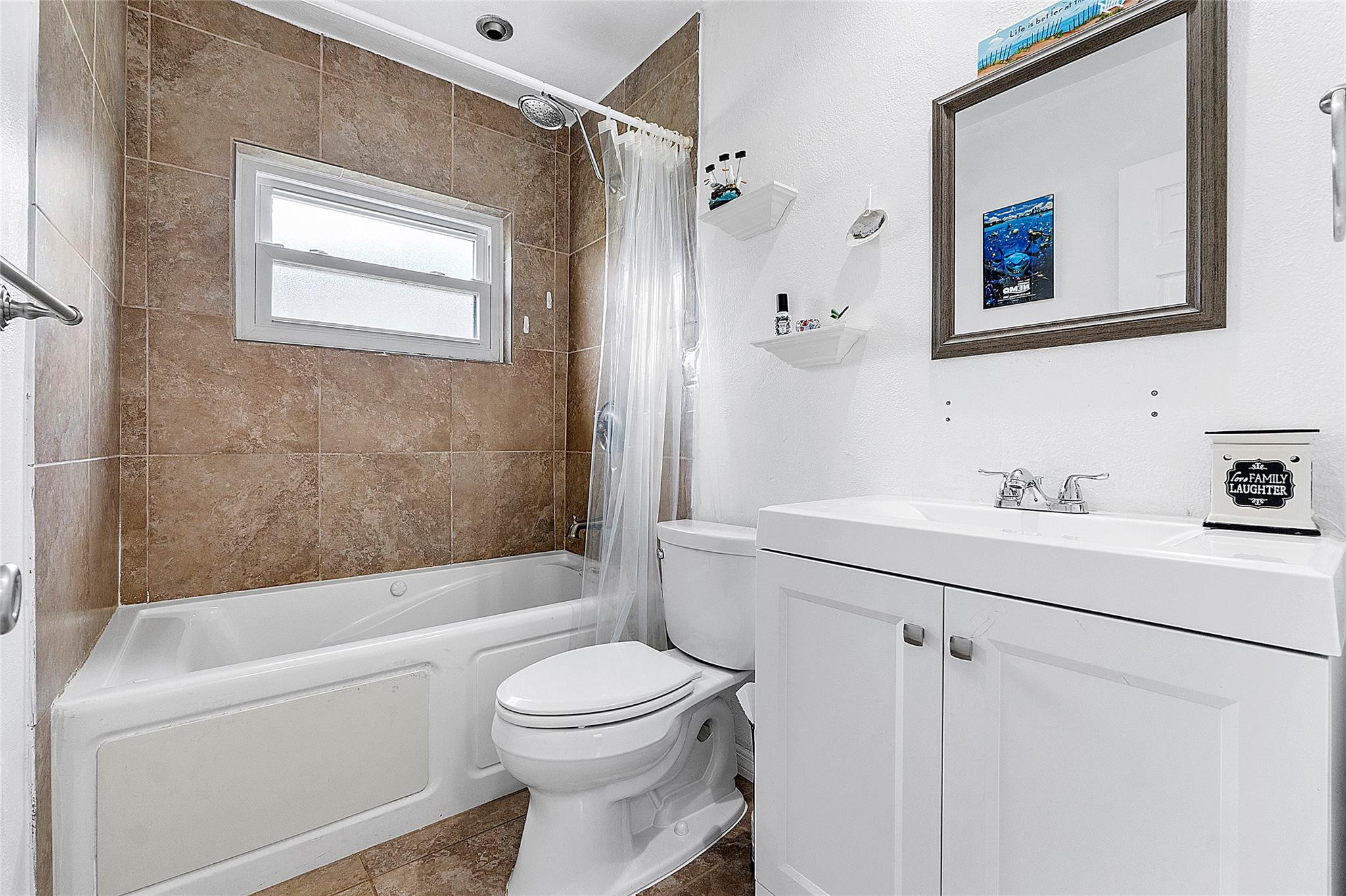 9804 Northwest 70th Street Tamarac, FL 33321 - Photo 5 of 12 a bathroom with a sink a toilet and shower
