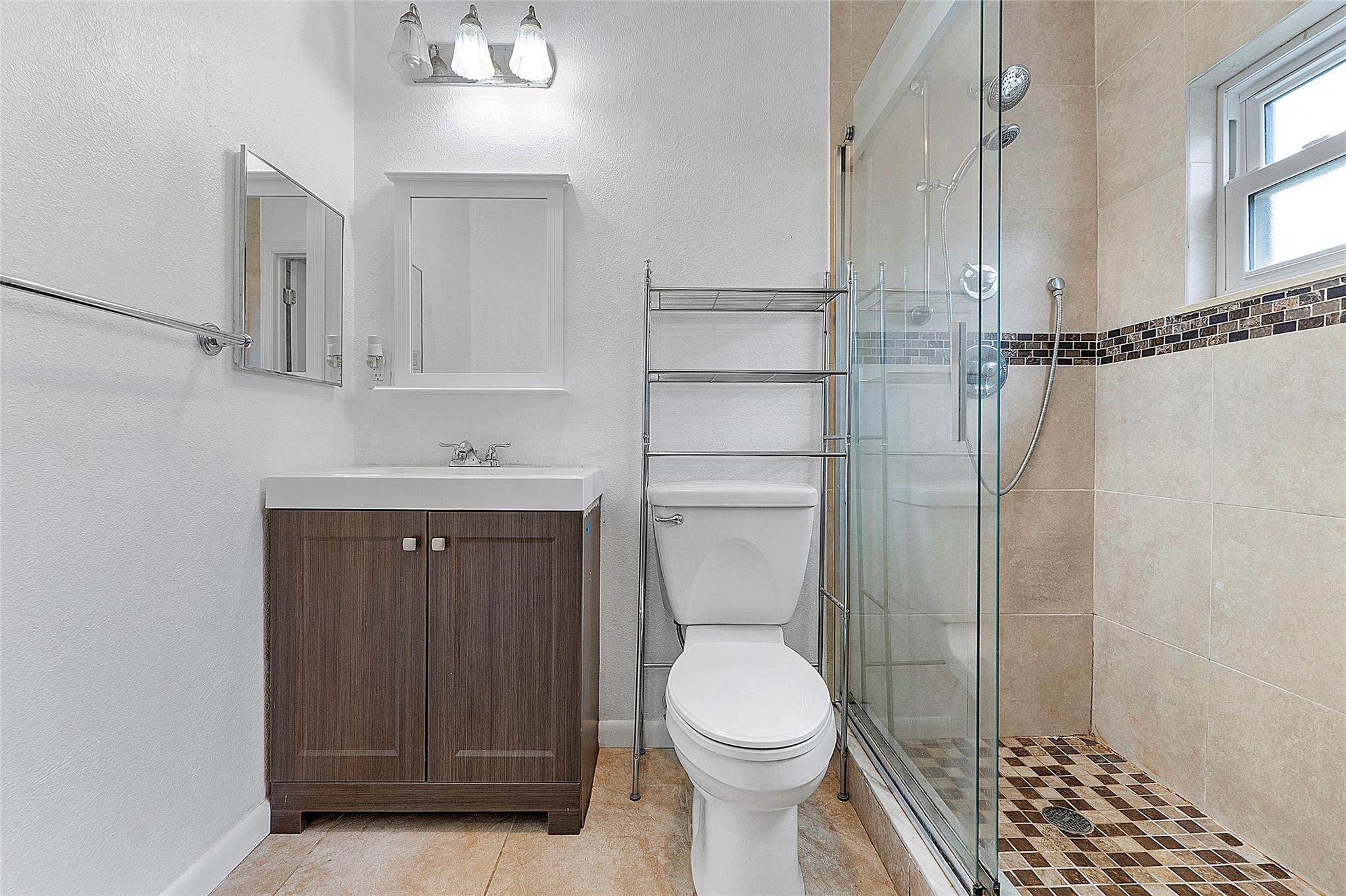 9804 Northwest 70th Street Tamarac, FL 33321 - Photo 7 of 12 a bathroom with a toilet a sink and shower