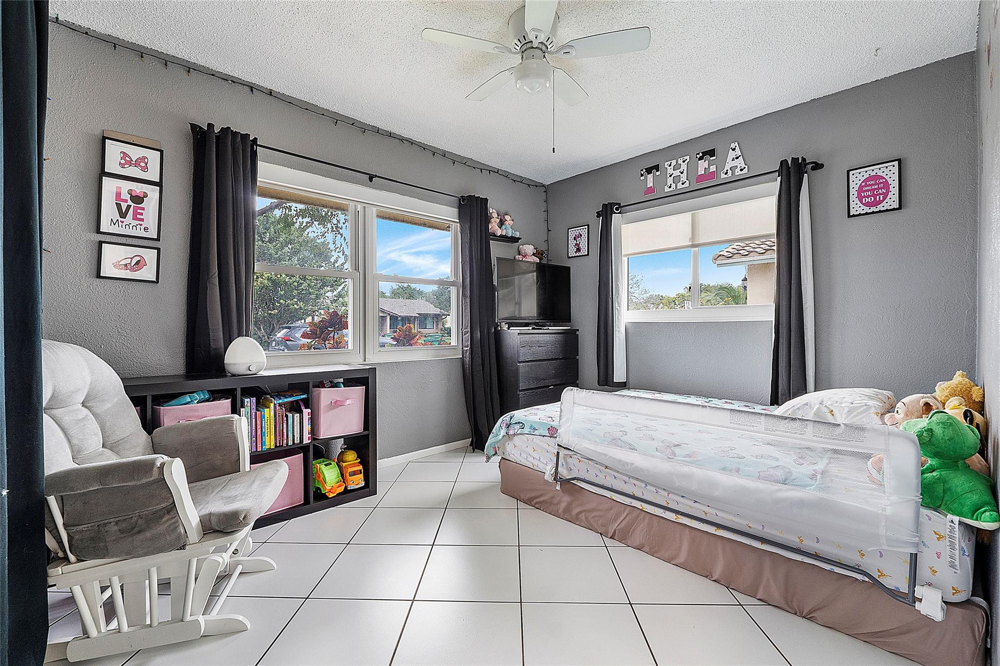 9804 Northwest 70th Street Tamarac, FL 33321 - Photo 8 of 12 a bedroom with a bed and a window