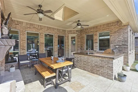 a view of a dinning table and chairs in the patio