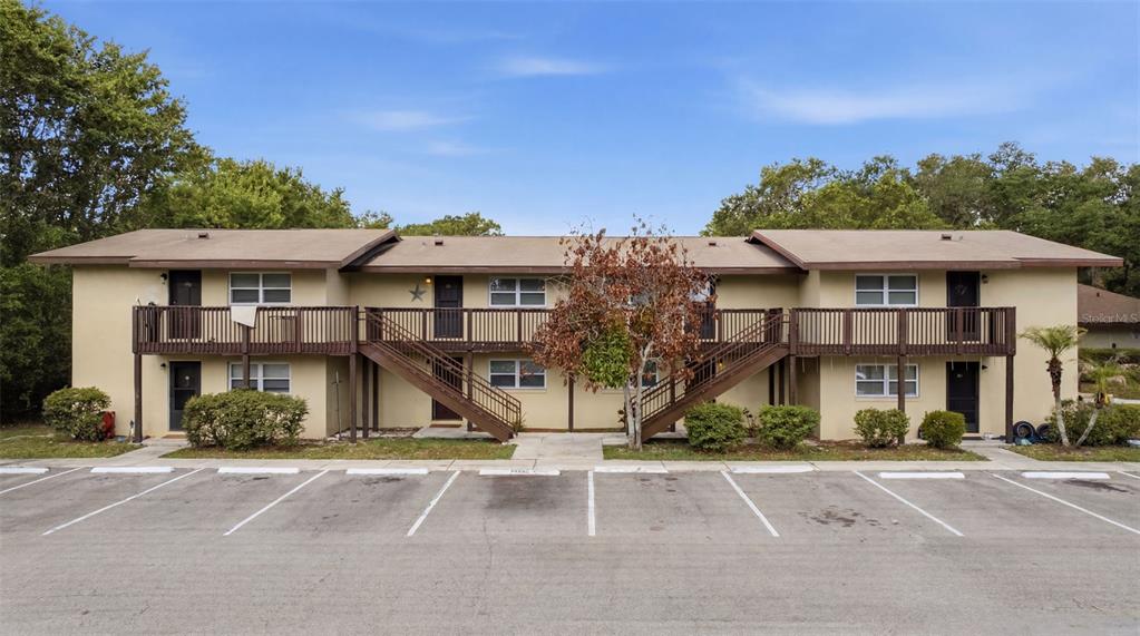 141 Fernery Road, Unit A3 Lakeland, FL 33809 - Photo 2 of 40 a front view of a residential apartment building with a yard