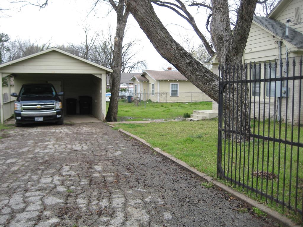3140 View Street Fort Worth, TX 76103 - Photo 17 of 21 a car parked in front of a house with a yard