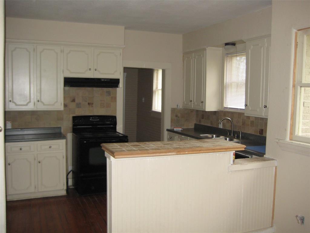 3140 View Street Fort Worth, TX 76103 - Photo 2 of 21 a kitchen with a sink a stove and refrigerator
