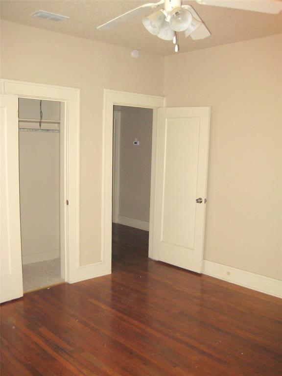 3140 View Street Fort Worth, TX 76103 - Photo 4 of 21 an empty room with wooden floor and closet area