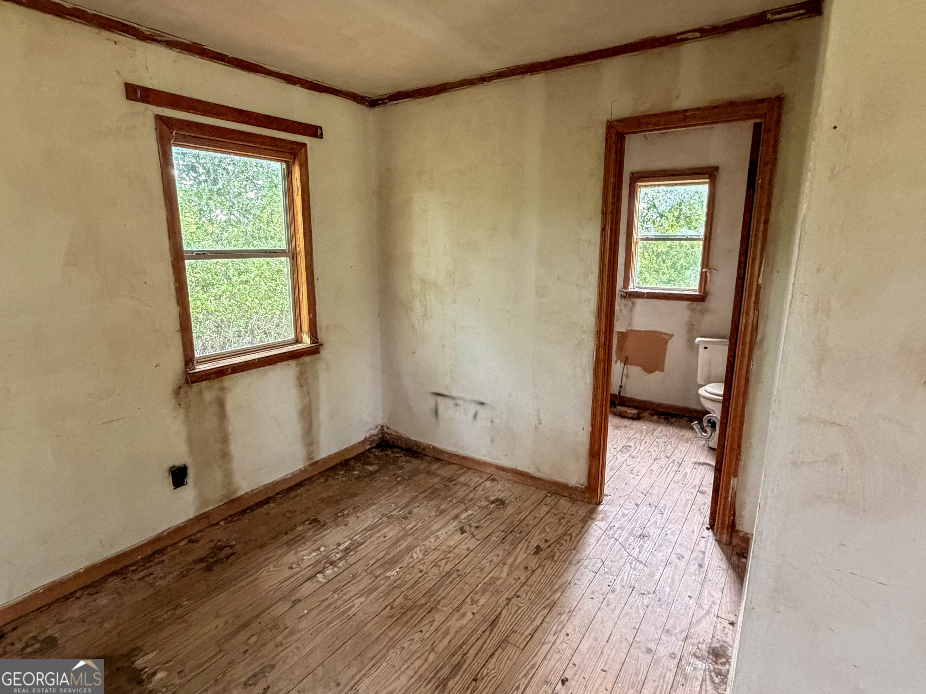 3925 Highway 441 Rentz, GA 31075 - Photo 8 of 16 a view of a hallway with wooden floor and a bedroom