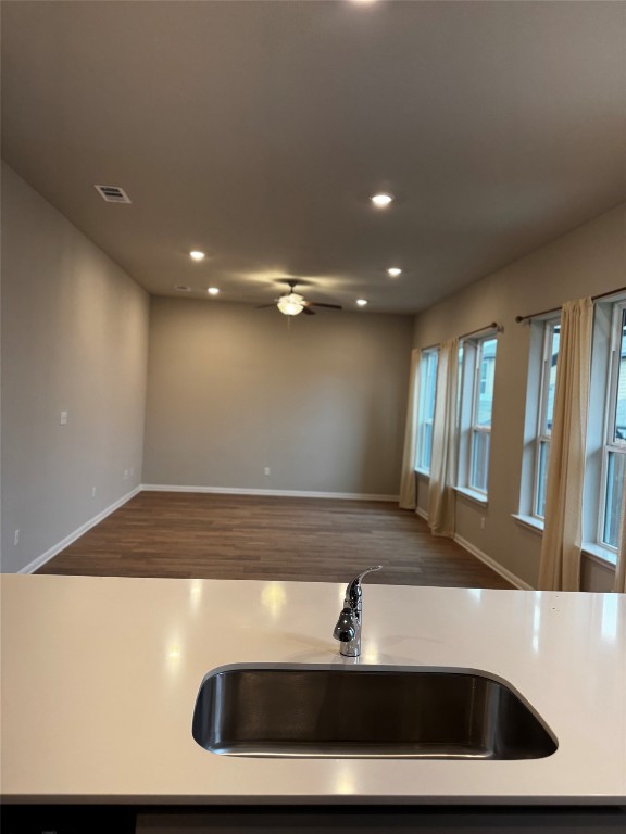 1020 Vista View Drive, Unit 2502 Georgetown, TX 78626 - Photo 15 of 15 Kitchen featuring open floor plan, recessed lighting, dark wood-style flooring, a ceiling fan, and light stone countertops