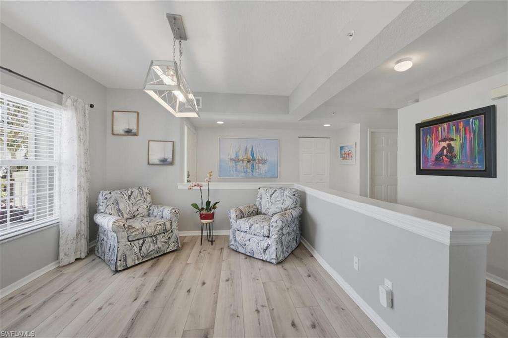 6899 Rain Lily Road, Unit 103 Naples, FL 34109 - Photo 16 of 39 Sitting room featuring light wood finished floors