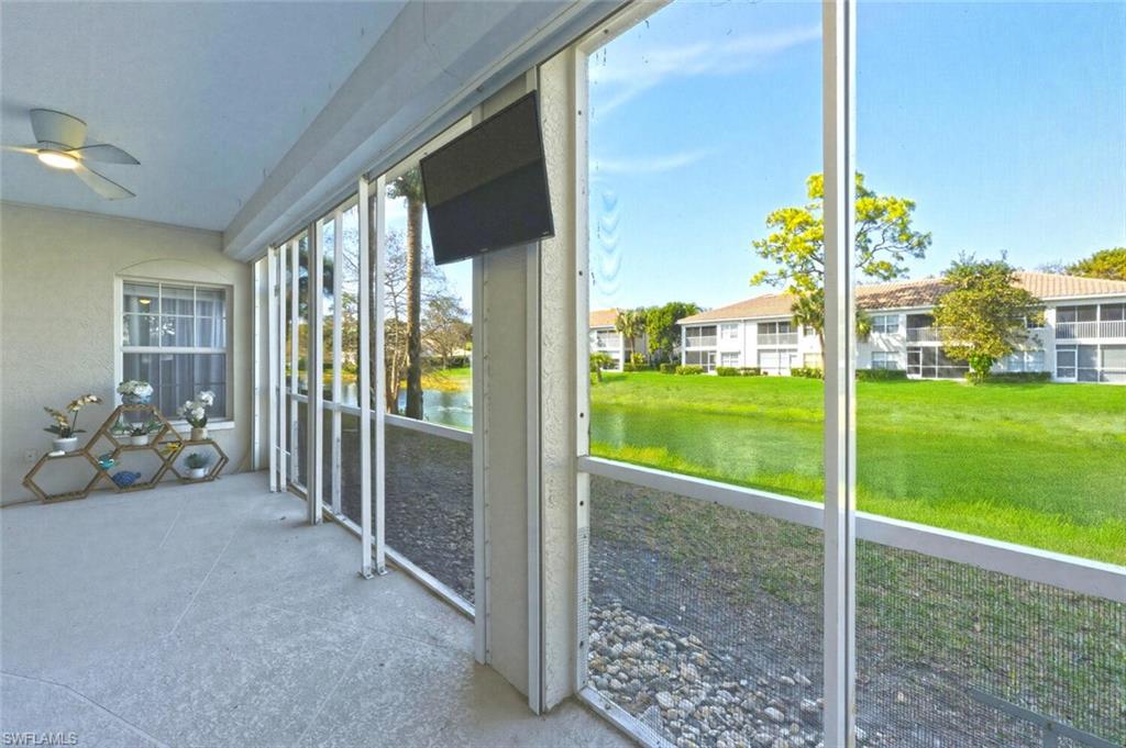 6899 Rain Lily Road, Unit 103 Naples, FL 34109 - Photo 25 of 39 Unfurnished sunroom with ceiling fan