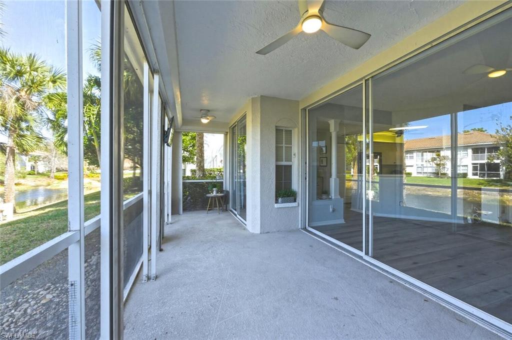 6899 Rain Lily Road, Unit 103 Naples, FL 34109 - Photo 26 of 39 Unfurnished sunroom featuring a ceiling fan and a water view