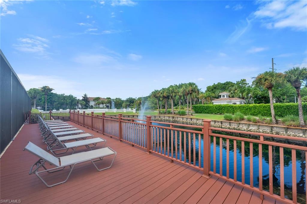 6899 Rain Lily Road, Unit 103 Naples, FL 34109 - Photo 35 of 39 Wooden deck with a water view and view of scattered trees