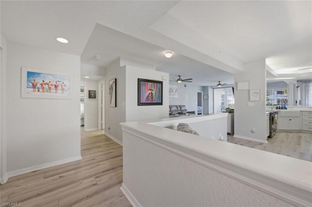 6899 Rain Lily Road, Unit 103 Naples, FL 34109 - Photo 4 of 39 Hall with light wood-style flooring and recessed lighting