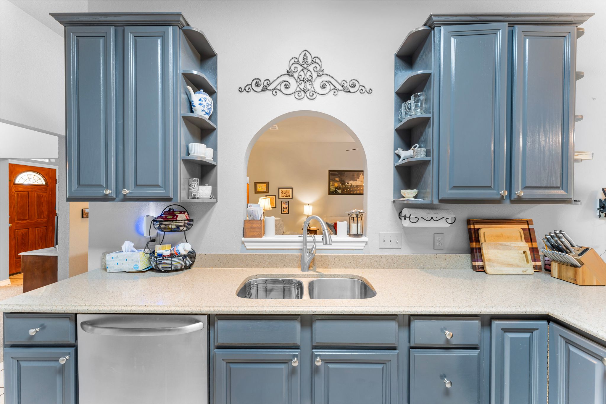 221 Breakaway Road Cedar Park, TX 78613 - Photo 26 of 39 Kitchen with open shelves, dishwasher, blue cabinetry, a sink, and light countertops